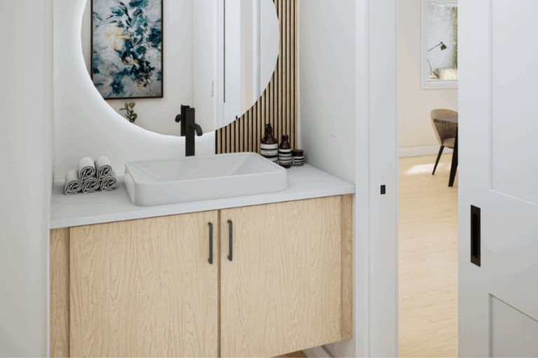 Modern bathroom vanity with round mirror and soft lighting in a Kings Crossing townhome in Abbotsford.